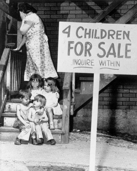 A mother hiding her face as she puts her children on sale (Chicago USA, 1948).